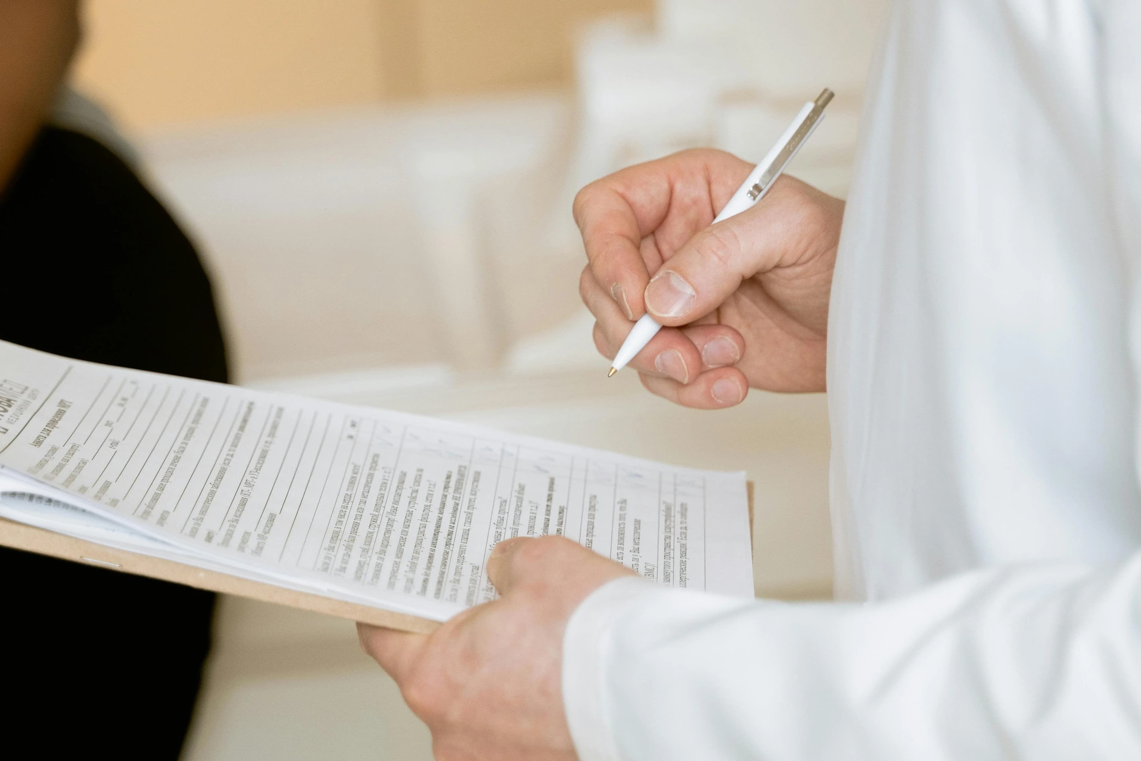 New patient filling out forms on a clipboard